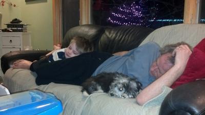 Teddy, my husband and grandson relaxing together on the couch.